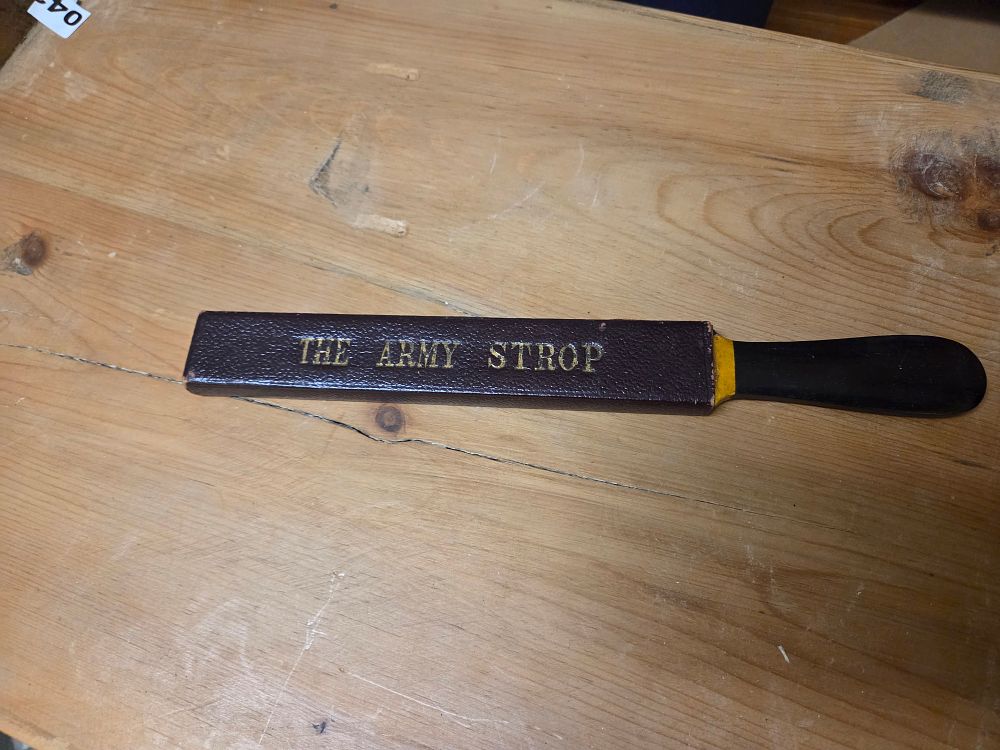 Lot 294 – A Vintage Leather Razor Strop branded The Army Strop