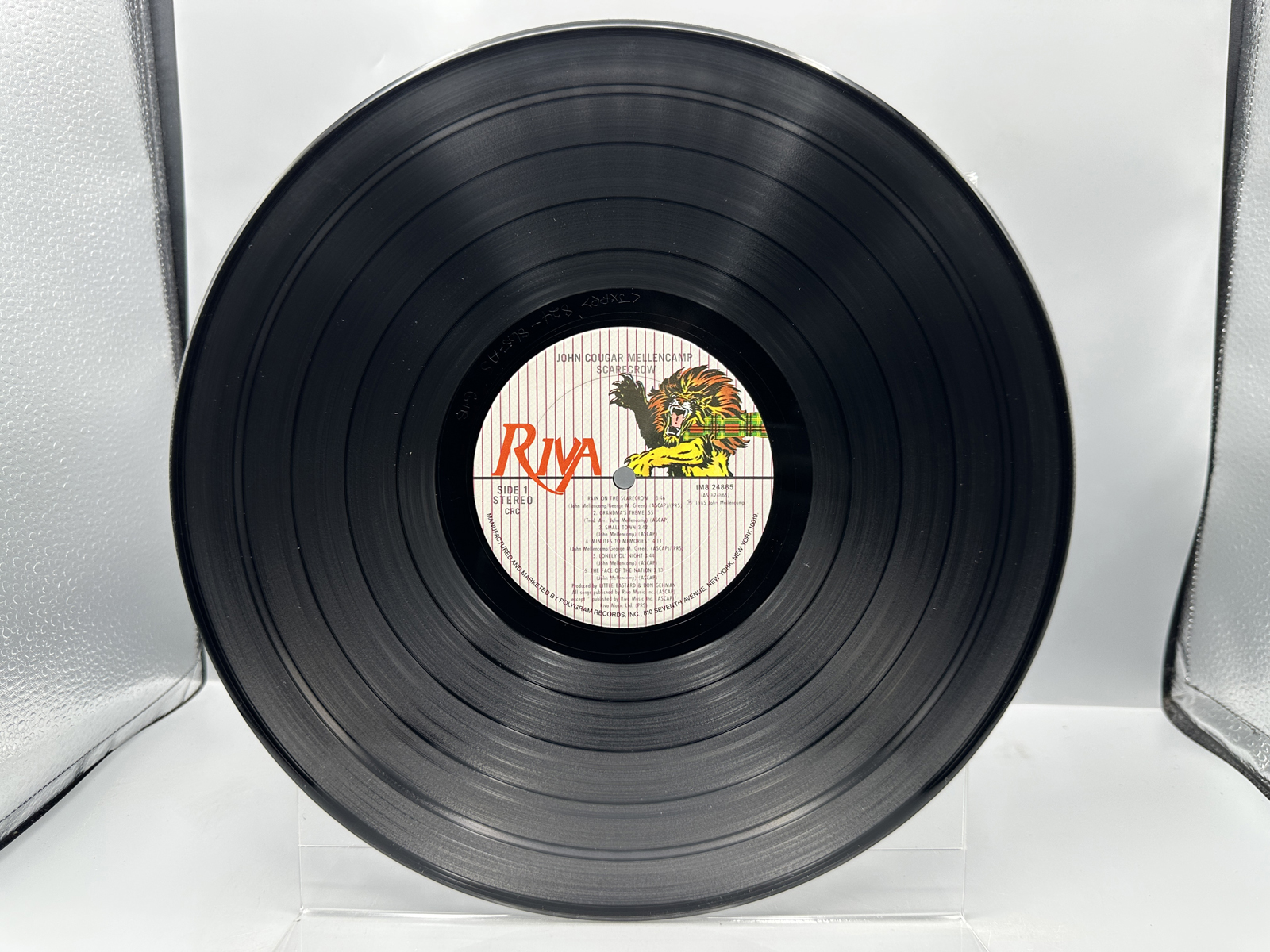 John Cougar Mellencamp: Scarecrow (1985), Club Edition; AND Three (3) 7-inch 45 rpm records with picture sleeves: Rumbleseat; Rain On the Sc