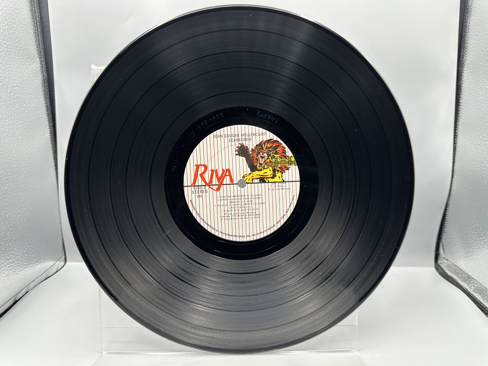 John Cougar Mellencamp: Scarecrow (1985), Club Edition; AND Three (3) 7-inch 45 rpm records with picture sleeves: Rumbleseat; Rain On the Sc