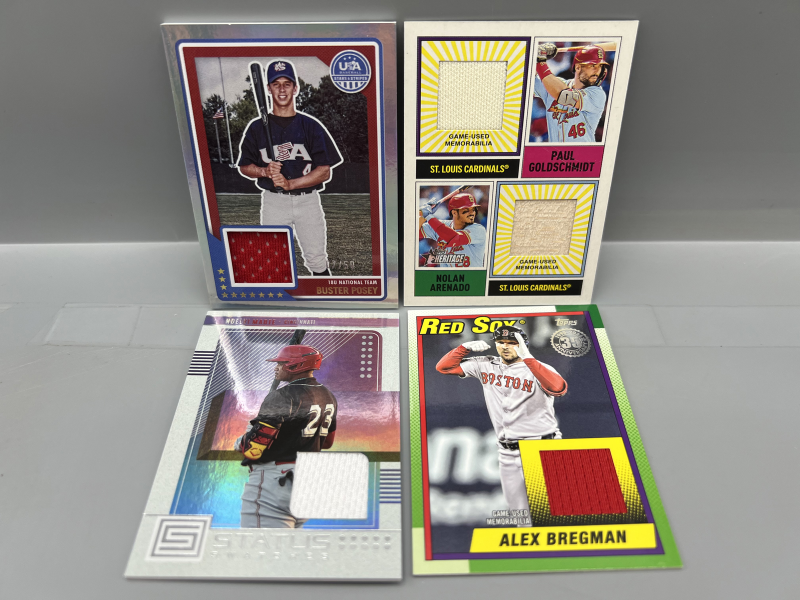 Lot of (4) Modern Baseball Star Player Relic Cards - Buster Posey, Paul Goldschmidt, Nolan Arenado, & Alex Bregman