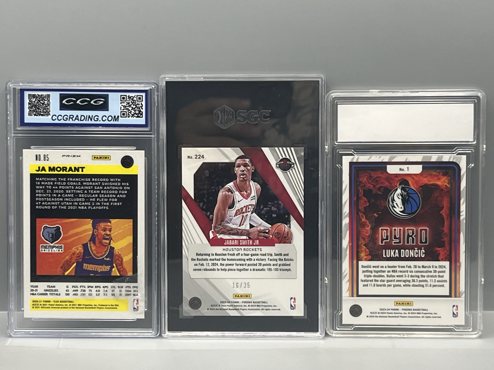 2020-21 Panini Flux Ja Morant Pulsar, 2023-24 Panini Phoenix Jabari Smith Blue #/35 SGC 9, & 2024 Panini Phoenix Luka Doncic Pyro #1