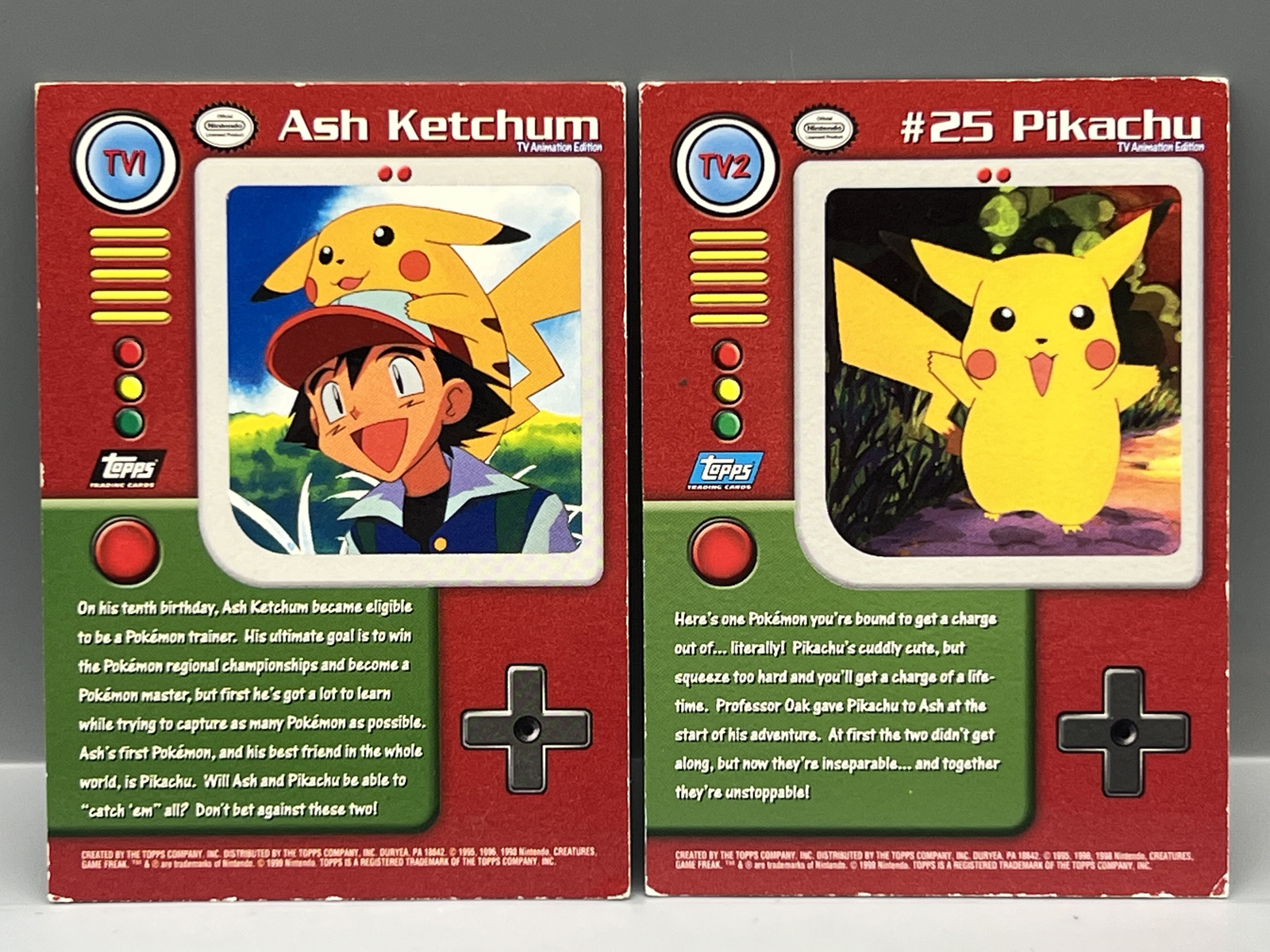 1999 Topps Pokemon TV Ash Ketchum 2nd Print Foil #TV1 & Pikachu 1st Print Foil #TV2