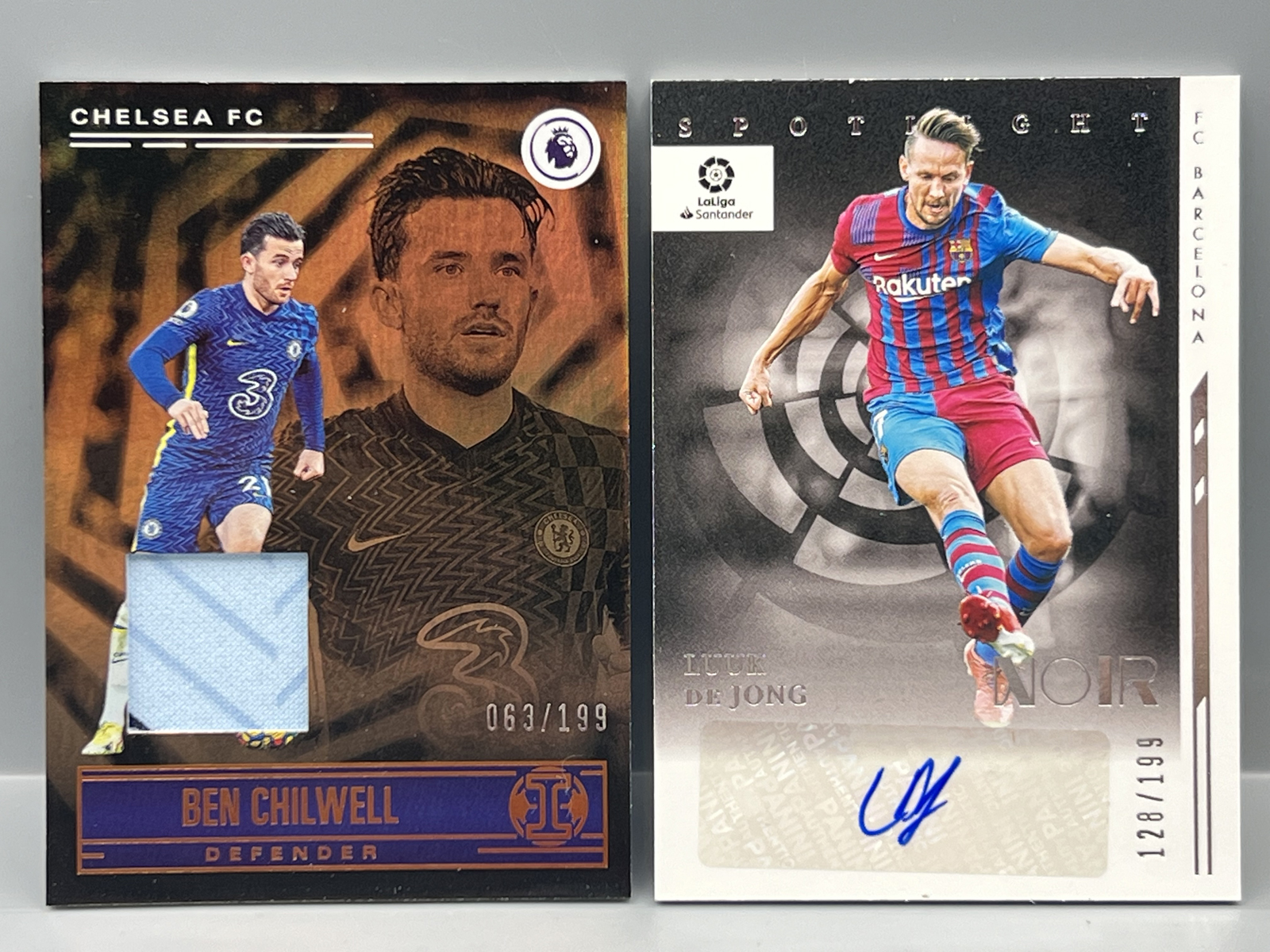 2021-22 Panini Chronicles Illusions Premier League Ben Chilwell Relic #/199 & 2021-22 Panini Chronicles Noir La Liga Luuk De Jong Auto #/199