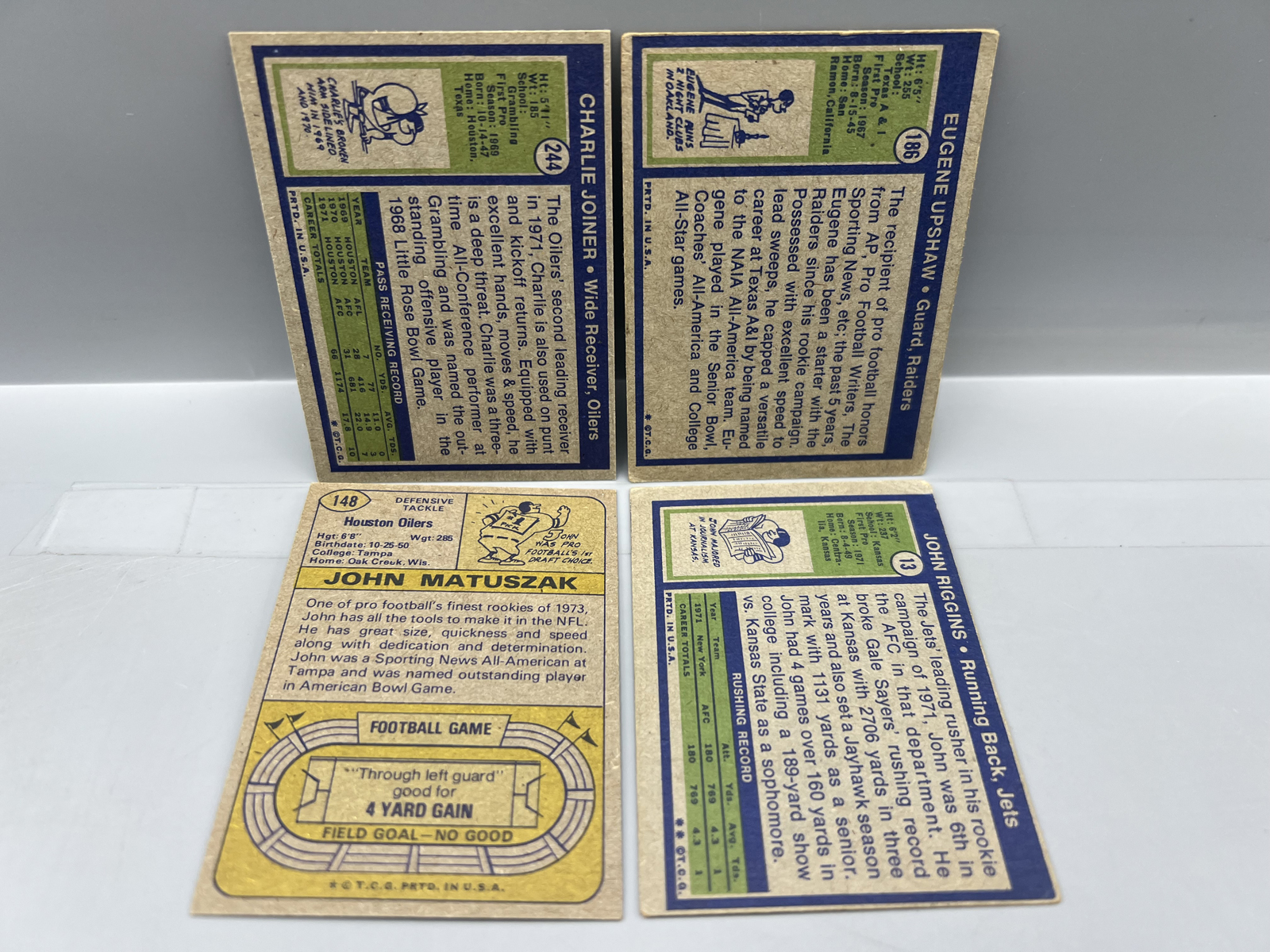(4) 1970s Topps Football Star Player Rookie Cards - Varying Conditions - Charlie Joiner, Eugene Upshaw, John Matuszak, & John Riggins