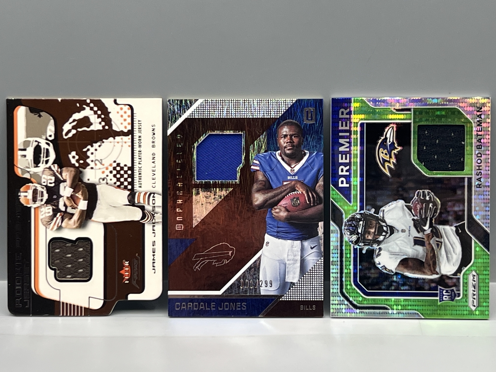(3) Assorted Football Jersey Relic Rookie Cards