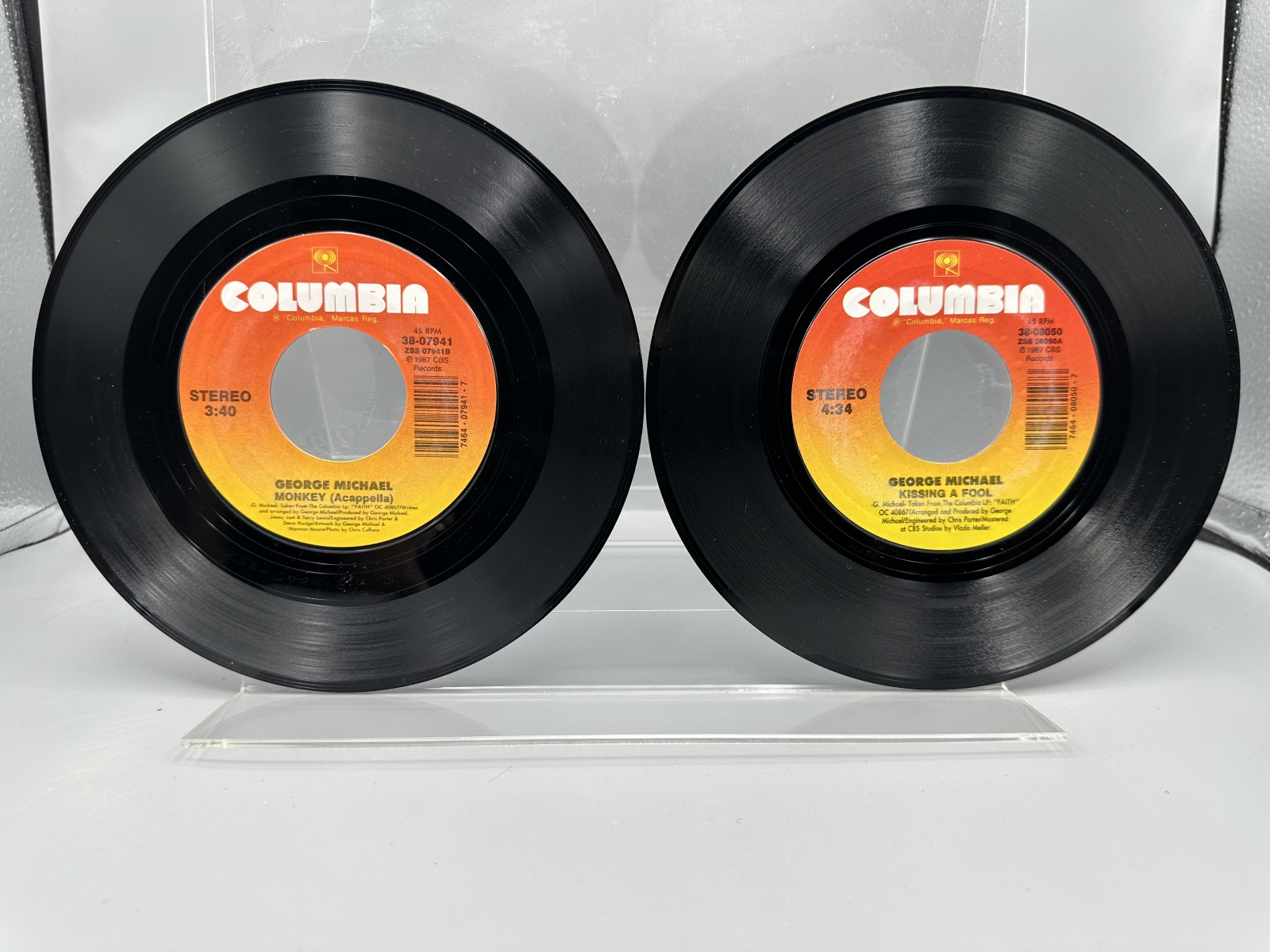 George Michael: Six (6) 7-inch 45 rpm records with picture sleeves: Faith (1987); Father Figure (1987); Monkey (1988); Kissing A Fool (1988)