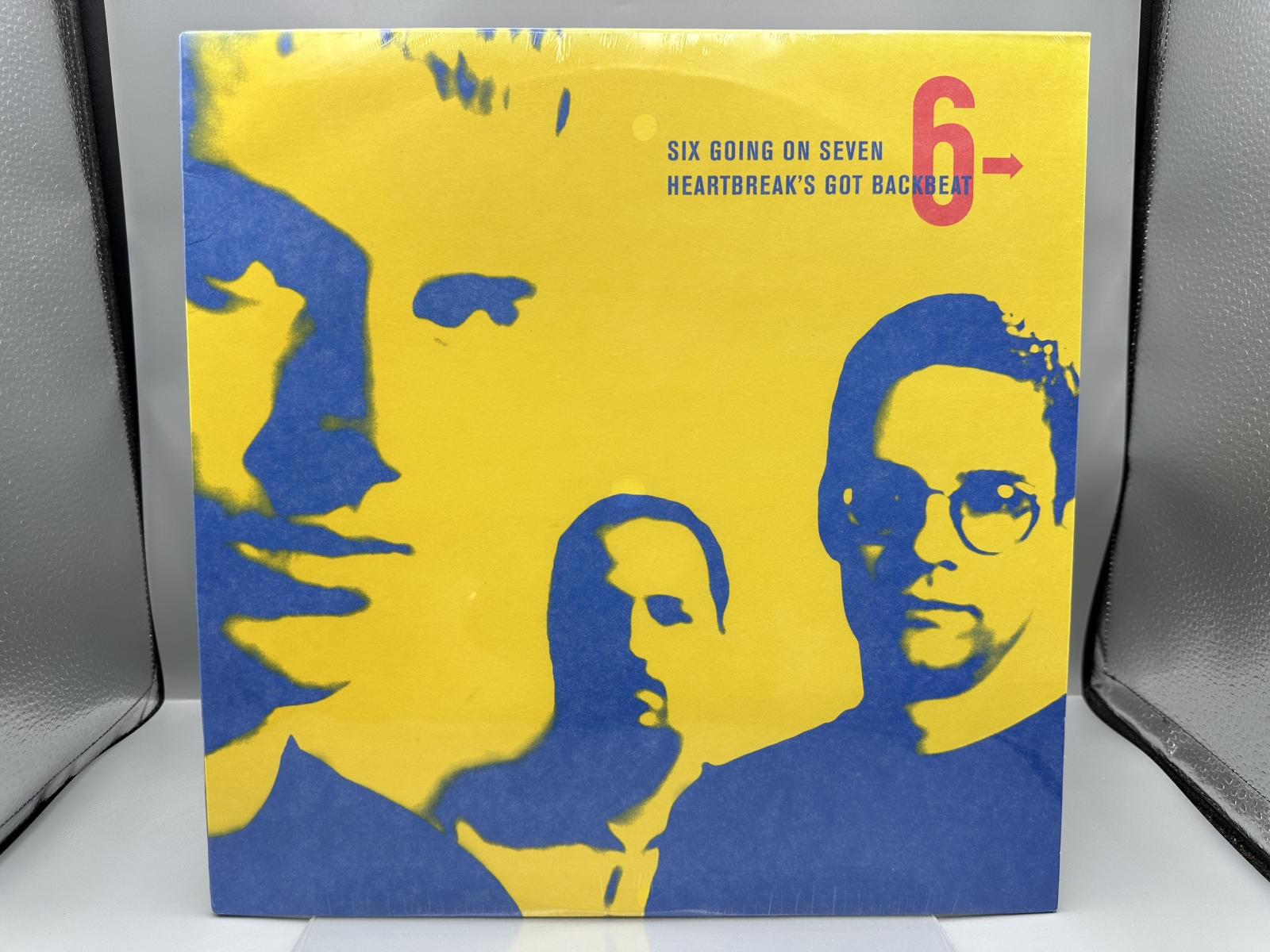 SEALED - Six Going On Seven: Heartbreak's Got Backbeat (1999). Since album is sealed, unknown if it is the white vinyl or black vinyl copy.