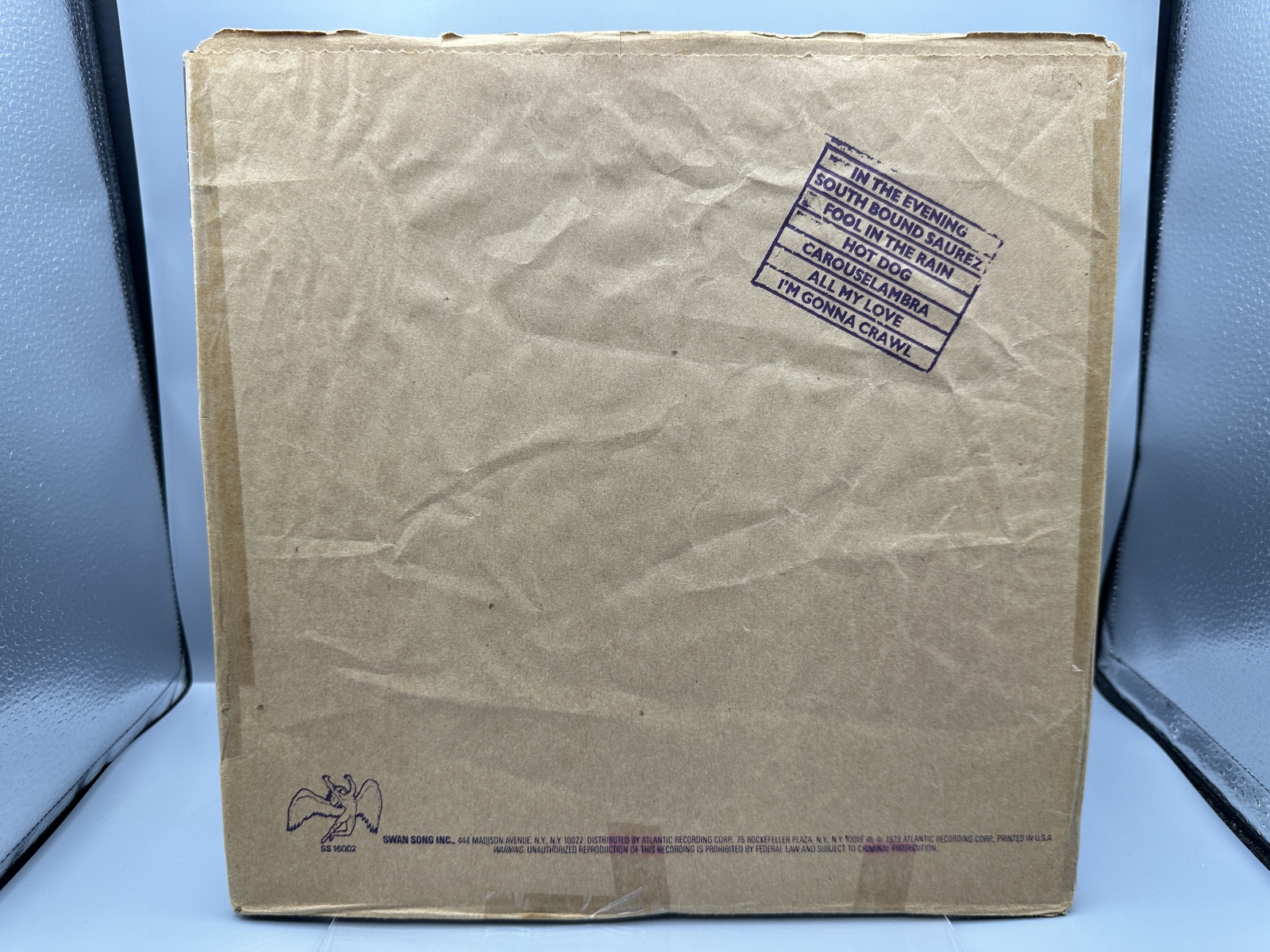 Led Zeppelin: In Through The Out Door (1979), Cover is Version 'C', outer sleeve (stamped paper bag) is included (but taped at seams), previ