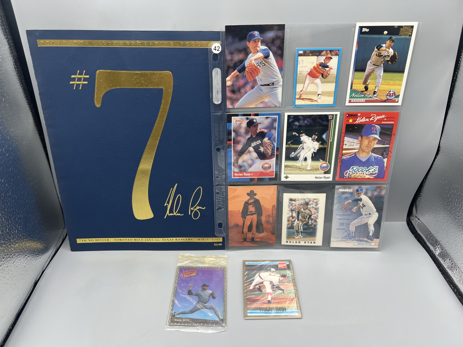 Assorted Nolan Ryan Memorabilia Lot W/ Cards, Unopened Packs, & 7th No Hitter Commemorative Program