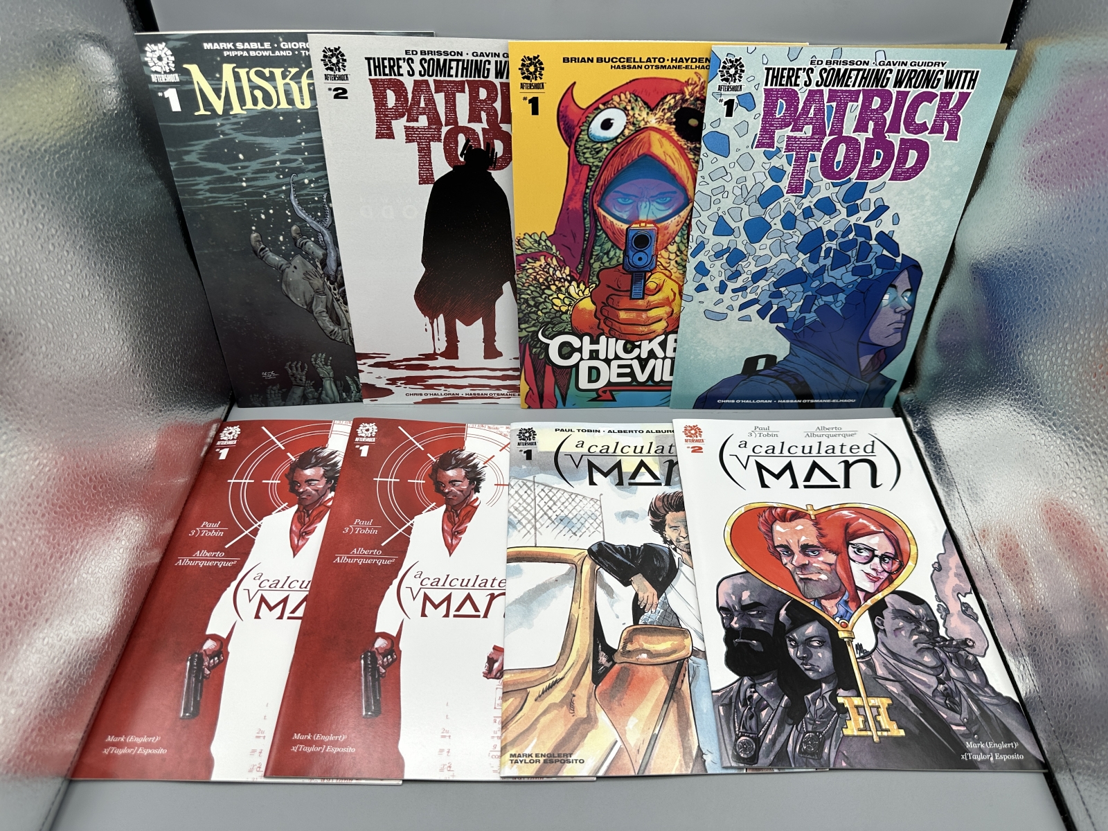 AfterShock Comics lot of 8 comics including Miskatonic #1, Chicken Devil #1, There's Something Wrong With Patrick Todd #1-2, and A Calculate
