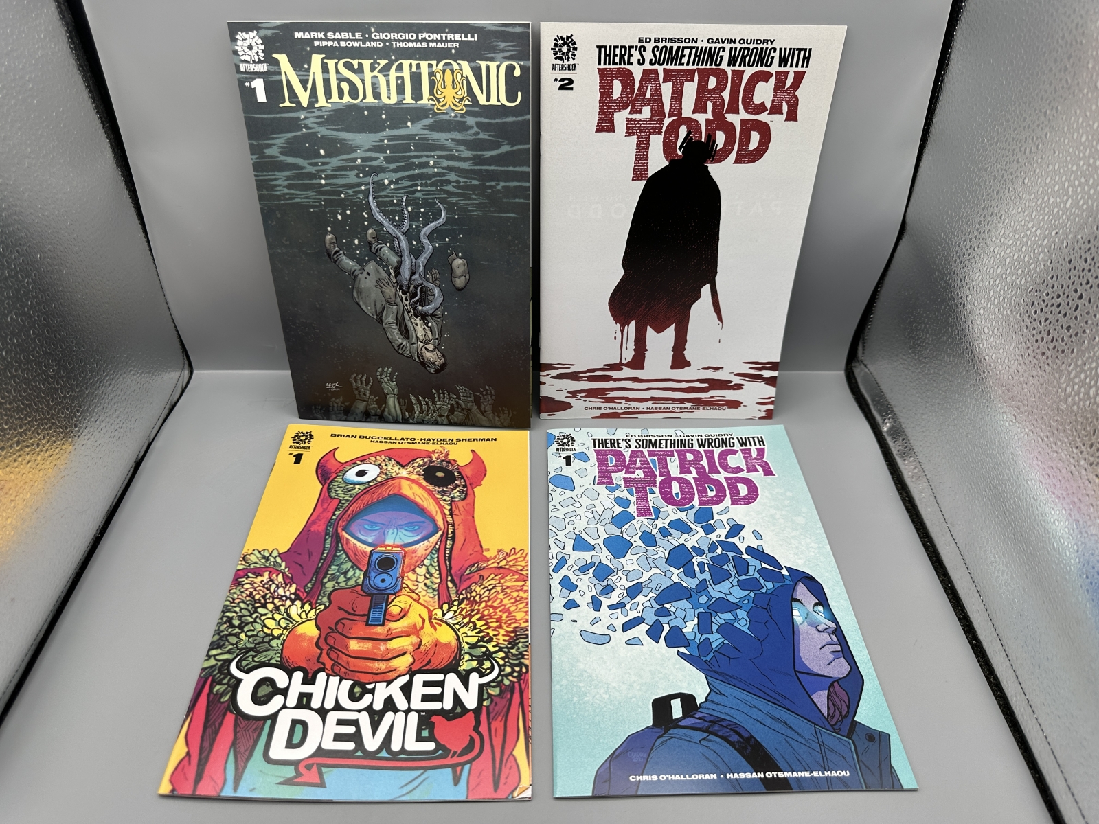 AfterShock Comics lot of 8 comics including Miskatonic #1, Chicken Devil #1, There's Something Wrong With Patrick Todd #1-2, and A Calculate