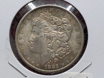 1885-O Morgan Dollar - MS63 Condition PLEASE NOTE Some coins may have a grade on the package or 