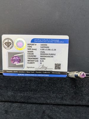 Oval Pinkish-Purple Stone, Approx. 0.41 Carats (Aurora Certification). An oval pinkish-purple 