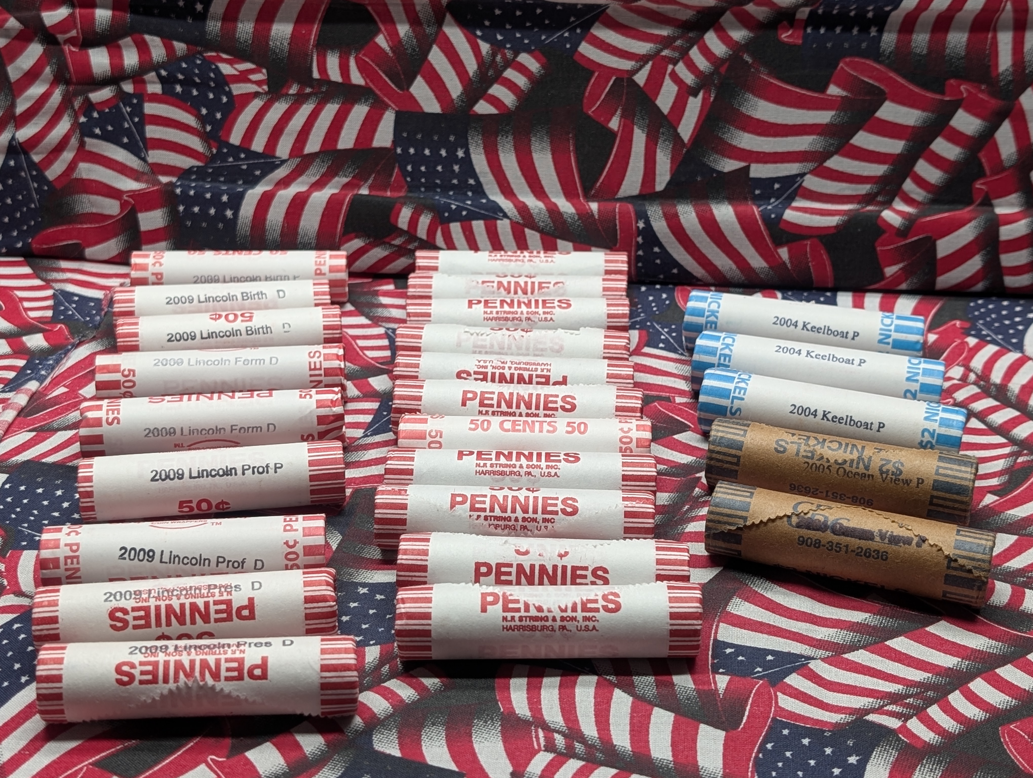 10 Rolls of 2009-P&D Lincoln Cents, 10 Rolls of Mixed Dates Lincoln Wheat Cents, 3 Rolls of 2004-P Keelboat Nickels and 2 Rolls of 2005-P Oc