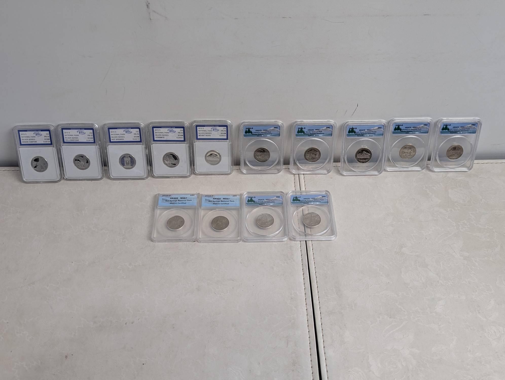 (5) 2010-S PROOF Various ATB Silver Quarters - All IGS Graded Cert. PR70 DCAM & (9) 2010-P&D and 2011-P Various ATB Quarters - All ANACS Cer