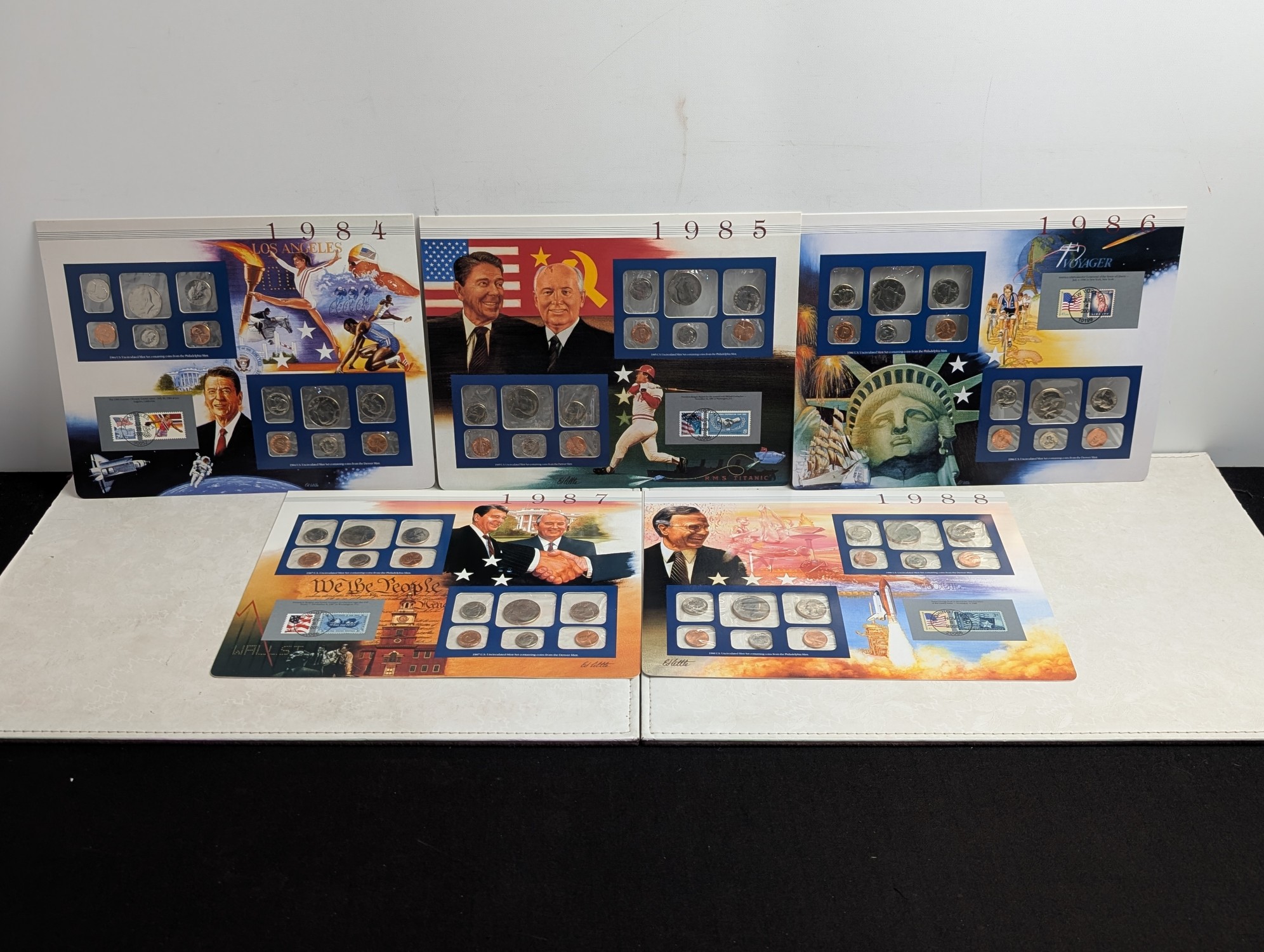 1984-1988 P&D U.S. Mint UNC Sets in Display w/ Commem Stamps (5 Sets)