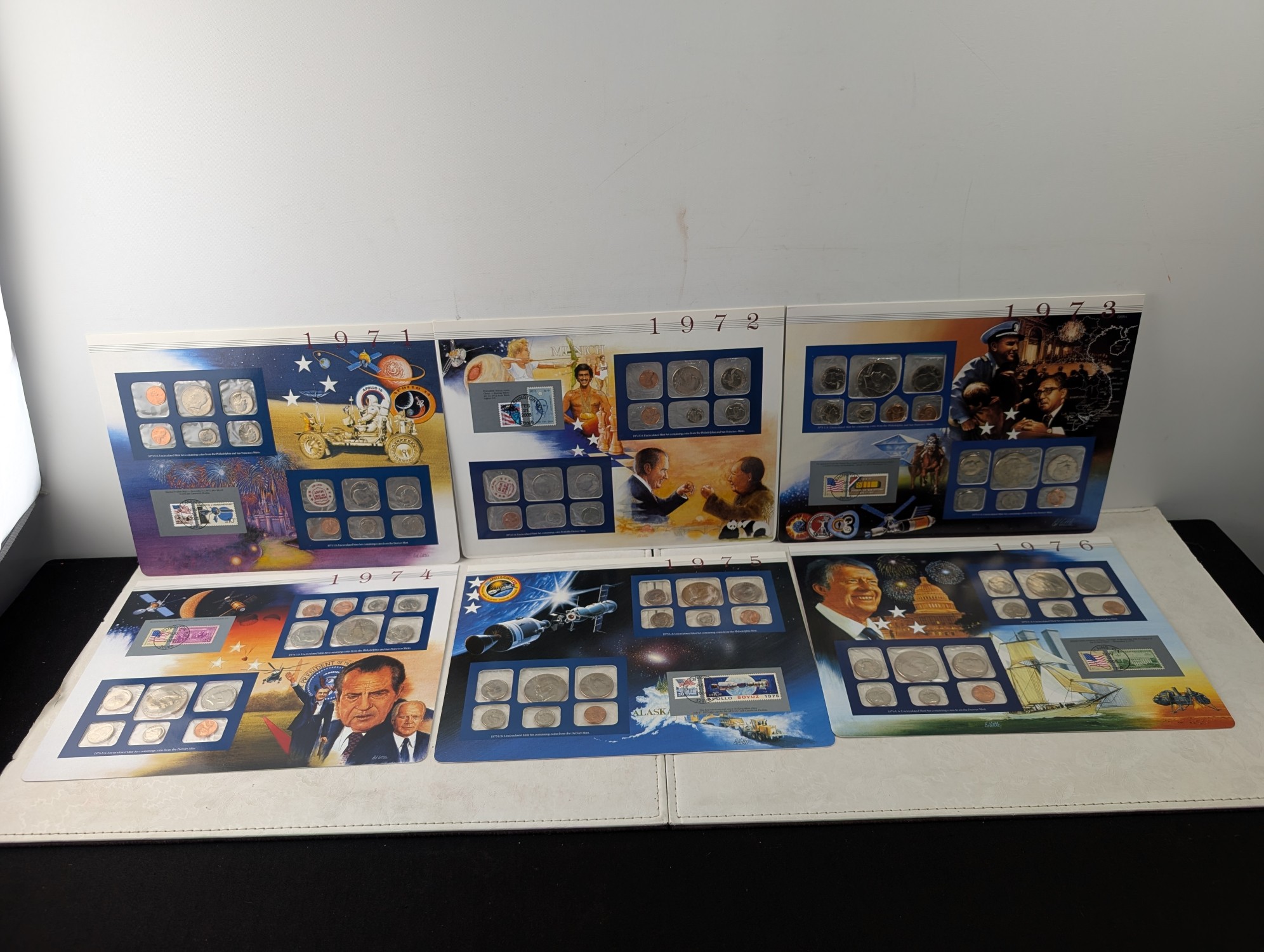 1971-1976 P&D U.S. Mint UNC Sets in Display w/ Commem Stamps (6 Sets)