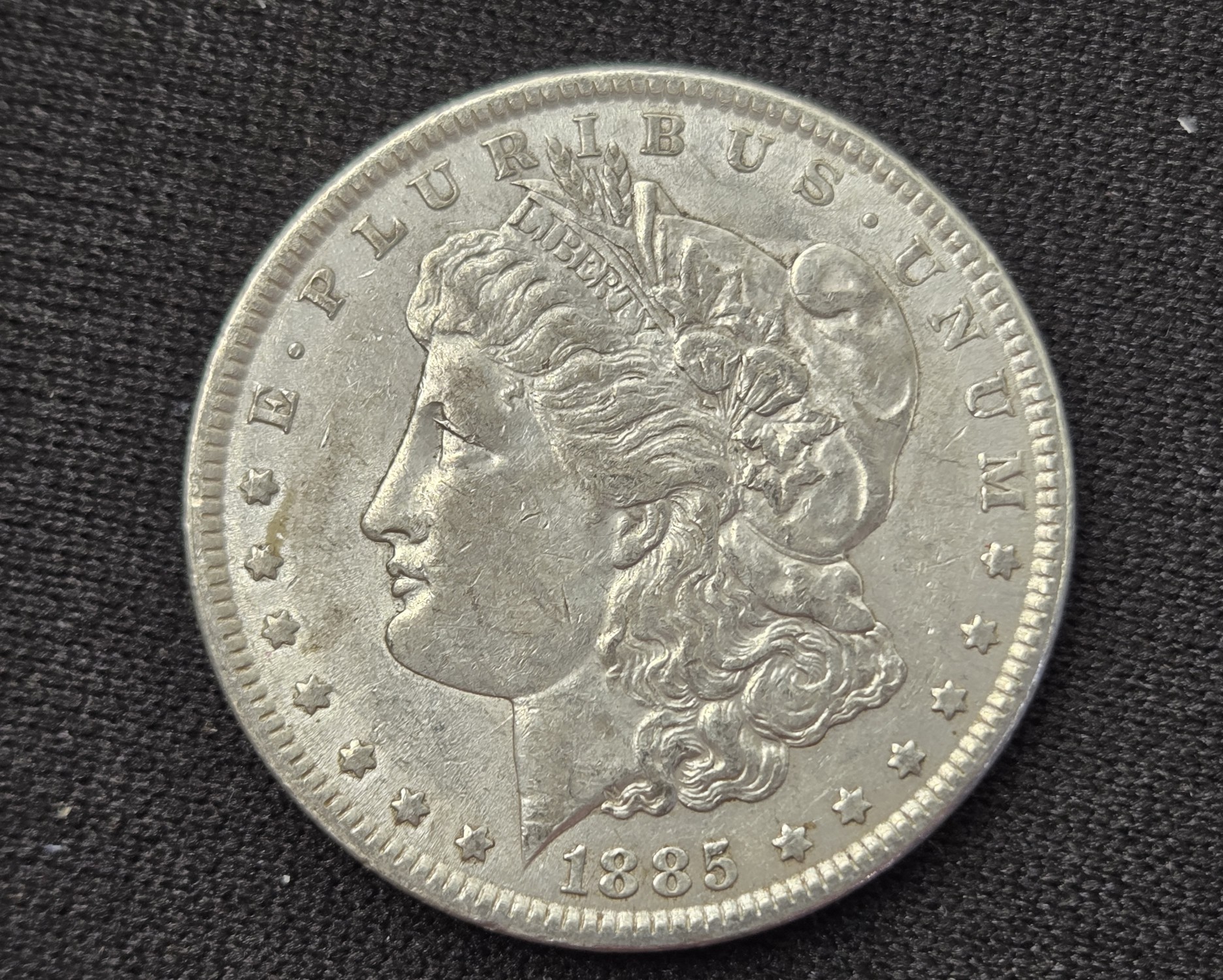 AU - 1885 Morgan 90% Silver Dollar