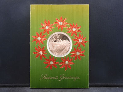 1973 Franklin Mint Seasons Greetings Proof Silver Dollar Sized Commemorative Coin in Plastic Sleeve.