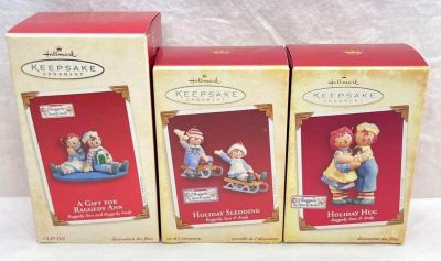 Hallmark Keepsake Ornaments Raggedy Ann and Andy lot of three Holiday Hug Holiday Sledding and 