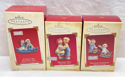 Hallmark Keepsake Ornaments Raggedy Ann and Andy lot of three Holiday Hug Holiday Sledding and 