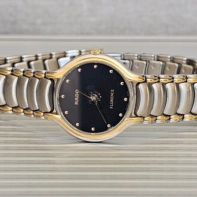 שעון Rado 23 מ"מ עם מנגנון קוורץ מופעל בסוללה בצבע זהב וכסוף עם לוח בצבע שחור עם סימני שימוש 