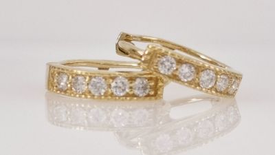 A pair of 14K gold hoop earrings set with 10 completely natural diamonds, a delicate and very 