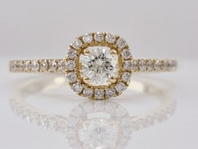 A 14K yellow gold ring set with natural diamonds in the shape of a square cushion, a central 