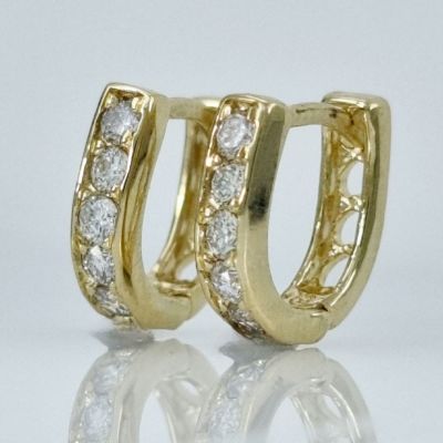 A pair of 14K gold hoop earrings in the shape of a horseshoe set with natural diamonds weighing 