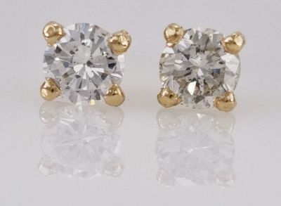 A pair of 14K gold earrings, a classic martini model set with natural diamonds, with a total 