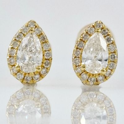 A pair of 14K gold ear studs studded with completely natural diamonds in stunning drop cuts 