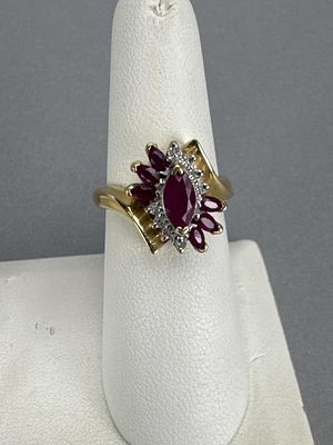 14K Yellow Gold Ladies Ruby and Diamond Ring. Marked 14K AJ P4 on shank. 8 round diamonds and 7 