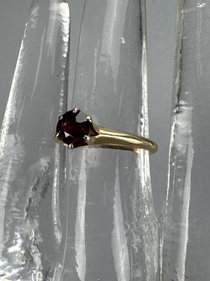 14K Yellow Gold Rhodolite Garnet Solitaire Ring. Rhodolite solitaire is 5.4mm and has a chip on 