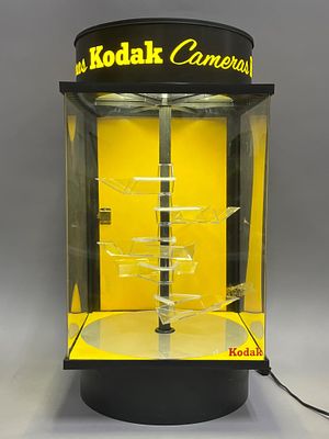 Kodak Display Case With Rotating Shelves. Lighted Kodak display case featuring a yellow and 