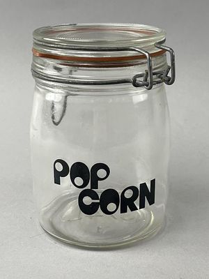 Glass Popcorn Jar with Wire Clamp. Clear glass jar with a clamp-style wire closure and an orange 