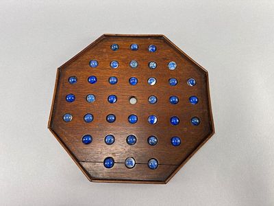 Octagonal Wood Solitaire Game w/ Marbles. Octagonal wooden solitaire game featuring 36 blue 