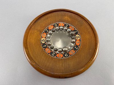 Vintage Tabletop Game with Metal Marbles. Vintage wooden tabletop game featuring a circular base 