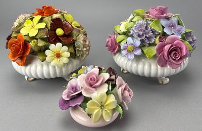 Adderley Porcelain Floral Arrangements, Ribbed Containers. Three decorative porcelain floral 