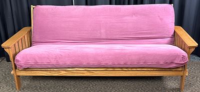 Wooden Futon with Pink Fabric Cushion. Wooden futon featuring a slatted wooden frame with 