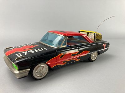 Tin Toy Car with Flame Decals and Speedometer Graphic. Tin toy car featuring a black body with a 