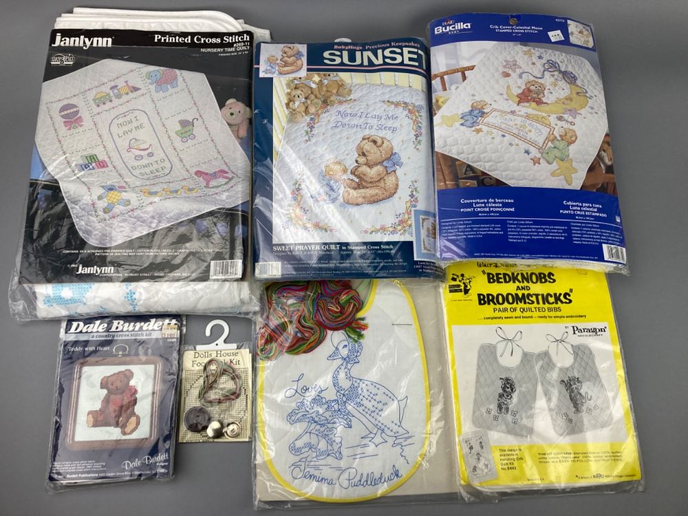 Assortment of Cross Stitch Kits and Quilted Bibs. Assortment of cross stitch kits and quilted 