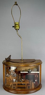 Handmade lamp featuring a wooden base with a diorama inside, covered by a plastic front. The 