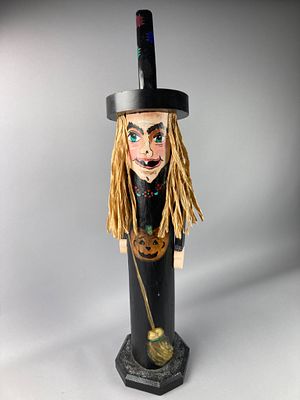 Hand-Painted Wooden Witch Figure with Broom. Wooden figure with a painted face and a black hat 