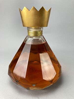 Factice Perfume Bottle with Crown Cap. Factice perfume bottle featuring a faceted glass design 