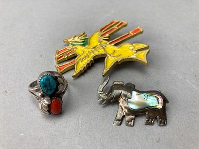 Silver Ring, Bird and Elephant Brooch Collection. A collection of three jewelry pieces: a silver 