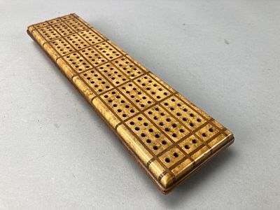 Wooden Cribbage Board with Pegs. Wooden cribbage board featuring multiple rows of holes and a 