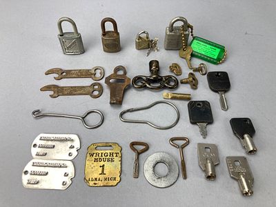 Assortment of Metal Locks, Keys, and Openers. Assortment of metal items including padlocks, keys 