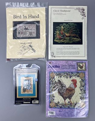 Four Packaged Needlework Kits with Various Designs. A collection of four packaged needlework 