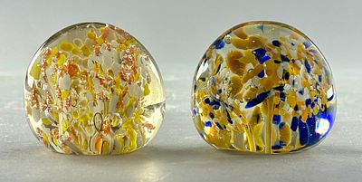 Two Glass Paperweights with Colorful Inclusions. Two glass paperweights featuring colorful 