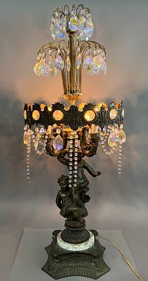 Ornate Metal and Crystal Lamp with Cherubs. Ornate metal lamp featuring cherub figures on the 
